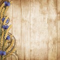 Wild flowers with spikelets on a wooden background Royalty Free Stock Photo