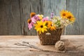 Wild flowers in vase, tangle of rope and scissors on old grunge Royalty Free Stock Photo