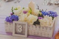 Wild flowers in a wooden tub on festive table