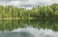 Wild forest lake. Gloomy sky, beautiful reflection Royalty Free Stock Photo