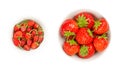 Wild and garden strawberries, fresh and ripe fruits in white bowls