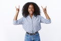 Wild good-looking attractive curly-haired african american woman party rock having fun showing heavy metal gestures Royalty Free Stock Photo