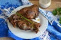 Wild hare or wild rabbit roasted with vegetables, on blue and white traditional napkin in gzhel style