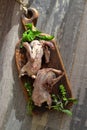 Wild hunting fowls in cooking. Two raw woodcocks on a rustic board with basil