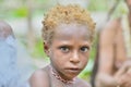 WILD JUNGLE, IRIAN JAYA, NEW GUINEA, INDONESIA - MAY 19, 2016: Closeup Portrait of unidentified Papuan little boy of Korowai tri