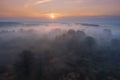 Wild jungle nature in mist at dawn from above. Autumn sunrise aerial view. Foggy nature in october morning