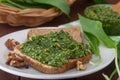 Wild leek pesto with olive oil and wallnuts on a wooden table