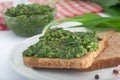 Wild leek pesto with olive oil on white background