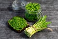 Wild leek pesto on a slice of bread with olive oil and salt on a wooden table with bread. Useful properties of wild garlic. Fresh Royalty Free Stock Photo