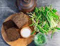 Wild leek pesto on a slice of bread with olive oil and salt on a wooden table with bread. Useful properties of wild garlic. Fresh Royalty Free Stock Photo