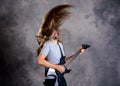 Wild musician with black guitar and flying hair Royalty Free Stock Photo