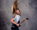 Wild musician with black guitar and flying hair Royalty Free Stock Photo