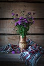 Wild meadow flowers cornflowers in a vase straw in the old farm