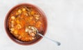 Wild mushroom mushroom soup in a brown clay plate and spoon on linen cloth, top view, copy space Royalty Free Stock Photo