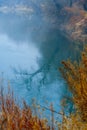 Wild natural landscape, late autumn season, river, bare branches of trees without leaves are reflected in the water, cloudy Royalty Free Stock Photo