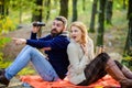 Wild outdoor. couple in love relax in autumn forest with tea or coffee. camping and hiking. surprised girl drink mulled Royalty Free Stock Photo