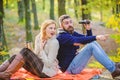 Wild outdoor. couple in love relax in autumn forest with tea or coffee. camping and hiking. surprised girl drink mulled Royalty Free Stock Photo