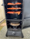 Wild Pacific Salmon fillet on gas smoker grill ready to cook Royalty Free Stock Photo