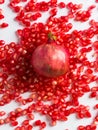 Wild pomegranate lies on the scattered grains of pomegranate on