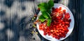 Wild ripe strawberries on a wooden rustic table with withe flowers. Bright shadows on a Sunny day on the terrace. Royalty Free Stock Photo