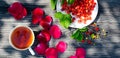 Wild ripe strawberries on a wooden table and Cup of tea. Bright shadows on a Sunny day on the terrace. Royalty Free Stock Photo