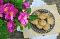 Wild rose bunch and homemade cookie Royalty Free Stock Photo