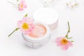 Wild rose dermatology cosmetic hygienic cream skincare product in jar on white background Royalty Free Stock Photo