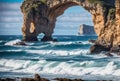 A wild and rugged coastline meets the relentless assault of crashing waves, carving out dramatic sea arches and caverns Royalty Free Stock Photo