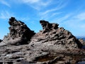 Wild sea rocks view against blue sky. Portoscuso, Sardinia Italy