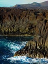 Wild sea waves crashing against a volcanic cliff in Lanzarote Canary Islands Royalty Free Stock Photo