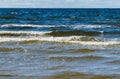 Wild seashore of the Baltic Sea with foam waves