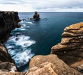 Wild shoreline and cliffs drop into a deep blue Atlantic Ocean