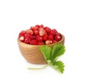 Wild small strawberries in a wooden bowl with leaves Royalty Free Stock Photo