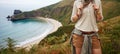 Adventure woman hiker in front of ocean view landscape