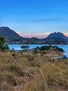 Wild Spanish nature landscape beautiful blue lake and mountains in clouds and pink sunset Royalty Free Stock Photo