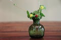 Wild strawberry bouquet in green glass vase