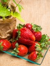 wild strawberry in pot and tasty fresh strawberrys in glass on sackcloth,nutrition, vitamin rich berry