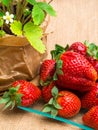 wild strawberry in pot and tasty fresh strawberrys in glass on sackcloth,nutrition, vitamin rich berry