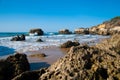 Wild summer ocean beach, Portugal. Clear sky, Rocks on sand Royalty Free Stock Photo