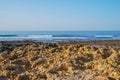 Wild summer ocean beach, Portugal. Clear sky, Rocks on sand Royalty Free Stock Photo
