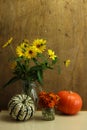 wild sunflowers in a vase and colorful pumpkins Royalty Free Stock Photo