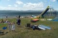 Wild tourist summer beach holiday with rubber boats in a tent town on the shore of lake Bolshoe