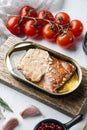 Wild Trout Canned smoked fish, on wooden cutting board, on white background with herbs and ingredients Royalty Free Stock Photo