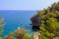 Wild Turkish beach in the Bay of the mountain coast of the Mediterranean Sea. August 7, 2022 Beldibi , Turkey Royalty Free Stock Photo