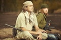 Wild warrior couple in field armed with handguns Royalty Free Stock Photo