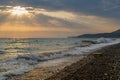 Wild waves on a pebble beach during a beautiful sunset Royalty Free Stock Photo