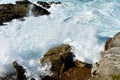 Wild waves splashing against the rocks. Blue sea with white foam, Galicia, Spain. Royalty Free Stock Photo