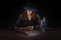 wild west girl with revolver gun sitting at the table with ammunition and silver coins Royalty Free Stock Photo