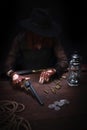 wild west girl with revolver gun sitting at the table with ammunition and silver coins Royalty Free Stock Photo