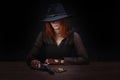 wild west girl with revolver gun sitting at the table with ammunition and silver coins Royalty Free Stock Photo